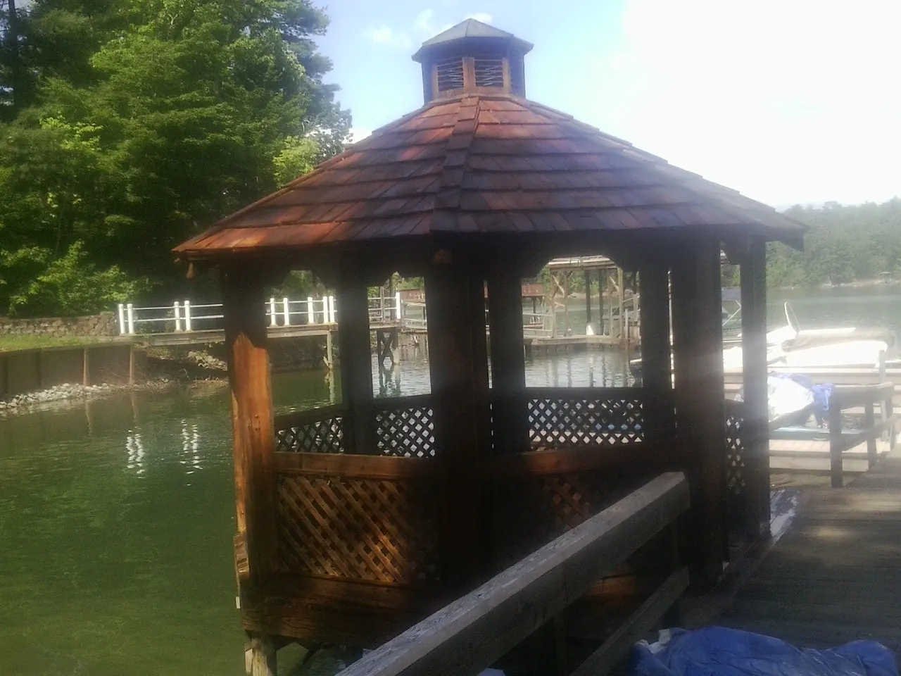 Cedar shake gazebo roof rebuilt on a lake dock in Allred